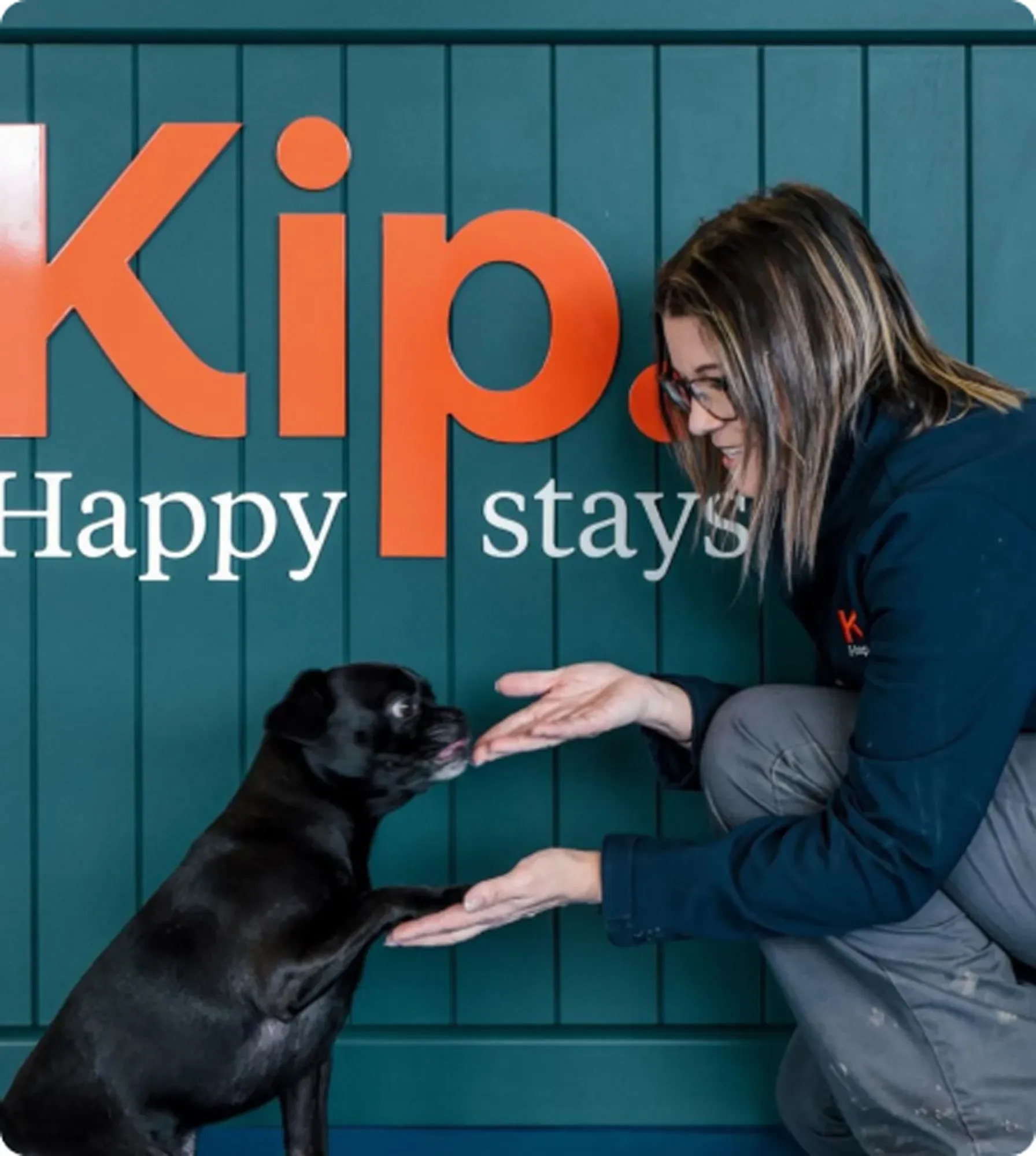 Dog giving paw to Kip staff
