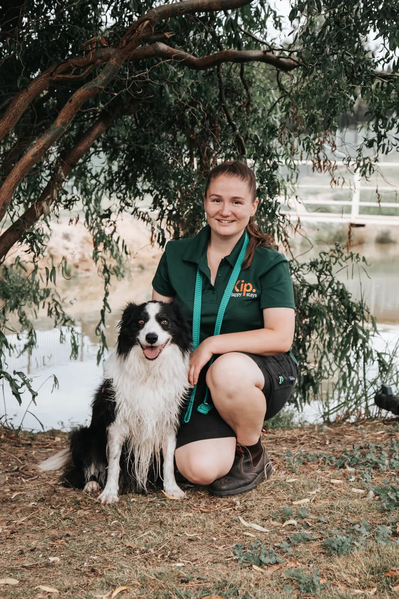 Kip employee with a dog in front of a lake